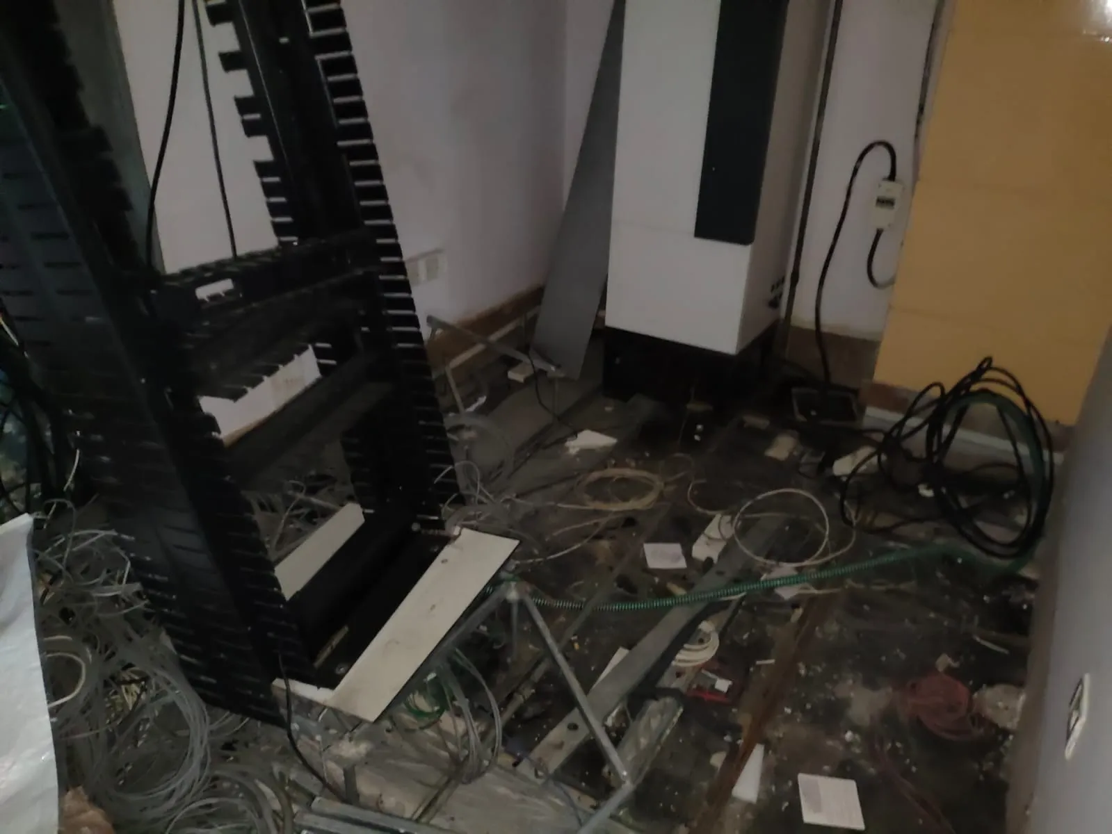 Server room decommissioning Bangalore — network cabling and server rack removal with raised access flooring dismantling in progress
