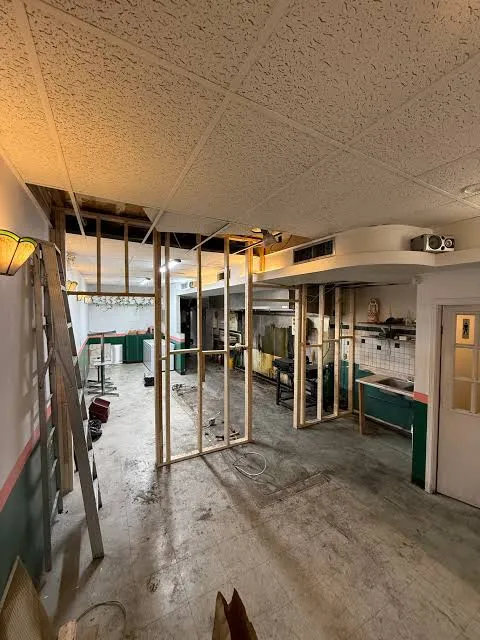 Commercial salon strip out Bangalore — styling chair removal and lighted vanity mirror dismantling in progress