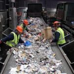 Home Workers sorting and segregating commercial dry waste on a conveyor belt line at the Urbane Eco Recyclers management plant in Bangalore