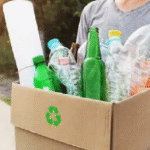 How Recycling Helps Your Business Save Money and the Environment A person holding a recycling box filled with plastic and glass bottles for dry waste collection services in Bangalore by Urban Eco Recyclers
