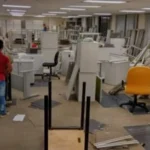 Bank and ATM Dismantling Services in Bangalore A worker managing structural furniture and partition frameworks during a commercial bank branch strip-out in Bangalore.