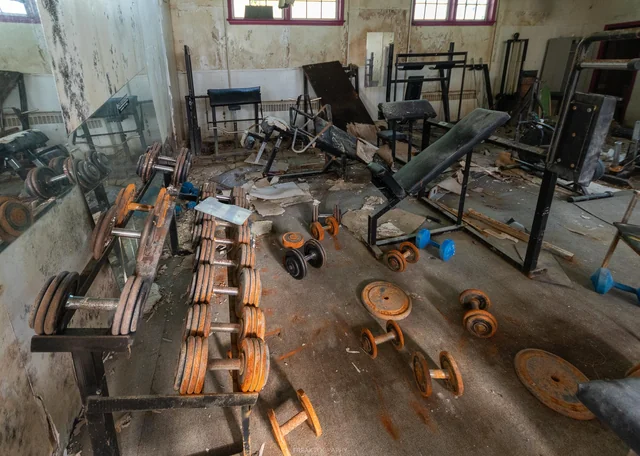 Commercial fitness scrap buyers Bangalore — recovered gym machines, weight plates and metal frames sorted for recycling after fitness studio strip out