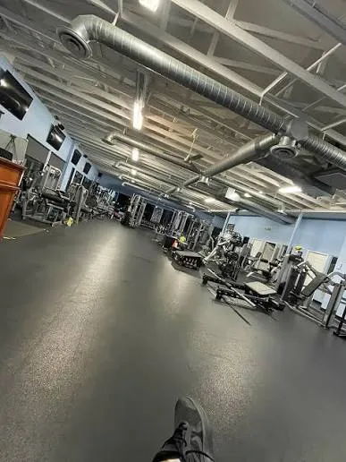 Gym and fitness centre dismantling services in Bangalore — Urban Eco Recyclers crew removing heavy gym equipment and rubber flooring from a fitness studio