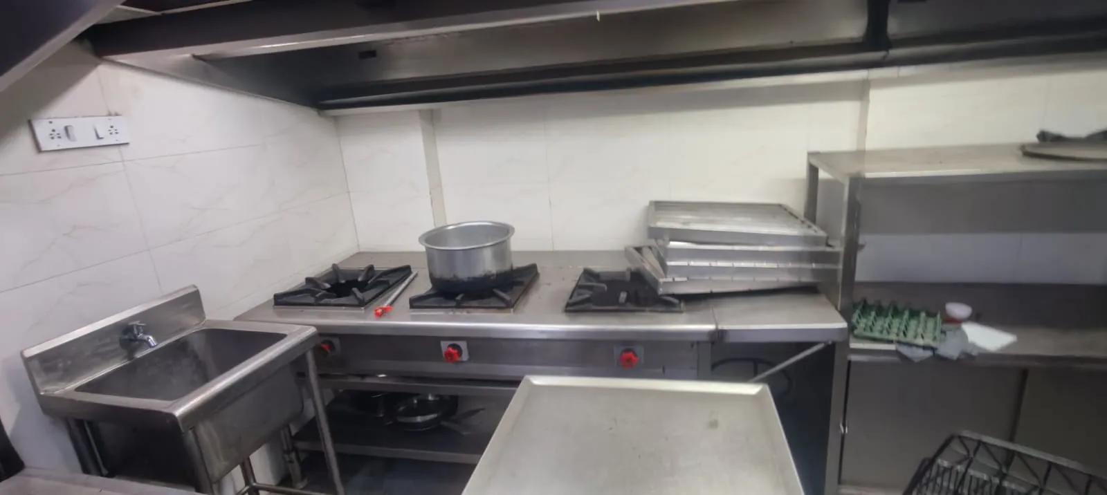Professional hotel kitchen dismantling services in Bangalore by Urban Eco Recyclers, featuring workers removing commercial kitchen equipment.