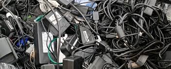 Discarded laptop chargers, power adapters, and copper wires separated at e-waste facility