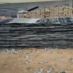 Stacked sheet metal scrap and AC ducting panels collected for debris recycling in Bangalore