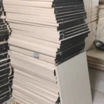 construction debris removal in bangalore Systematically stacked wooden partition boards and ceiling panels collected for debris removal in Bangalore